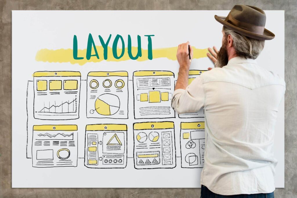 Man designing the layout of a web page in whiteboard